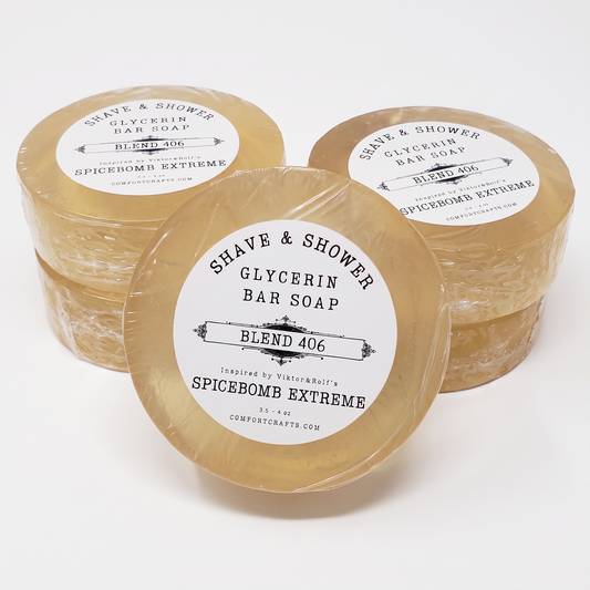 Three round translucent bar soaps wrapped in clear plastic with white paper labels, arranged on a clean white background. The front soap is most prominent, with two additional soaps behind it.