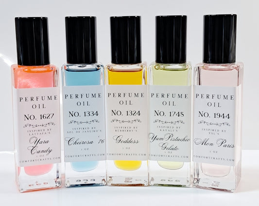 Six bottles of one ounce women's perfume oil with a pink, yellow, and orange floral background.