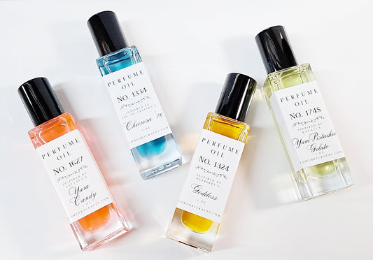 Four colorful 1 oz bottles of women's perfume oil