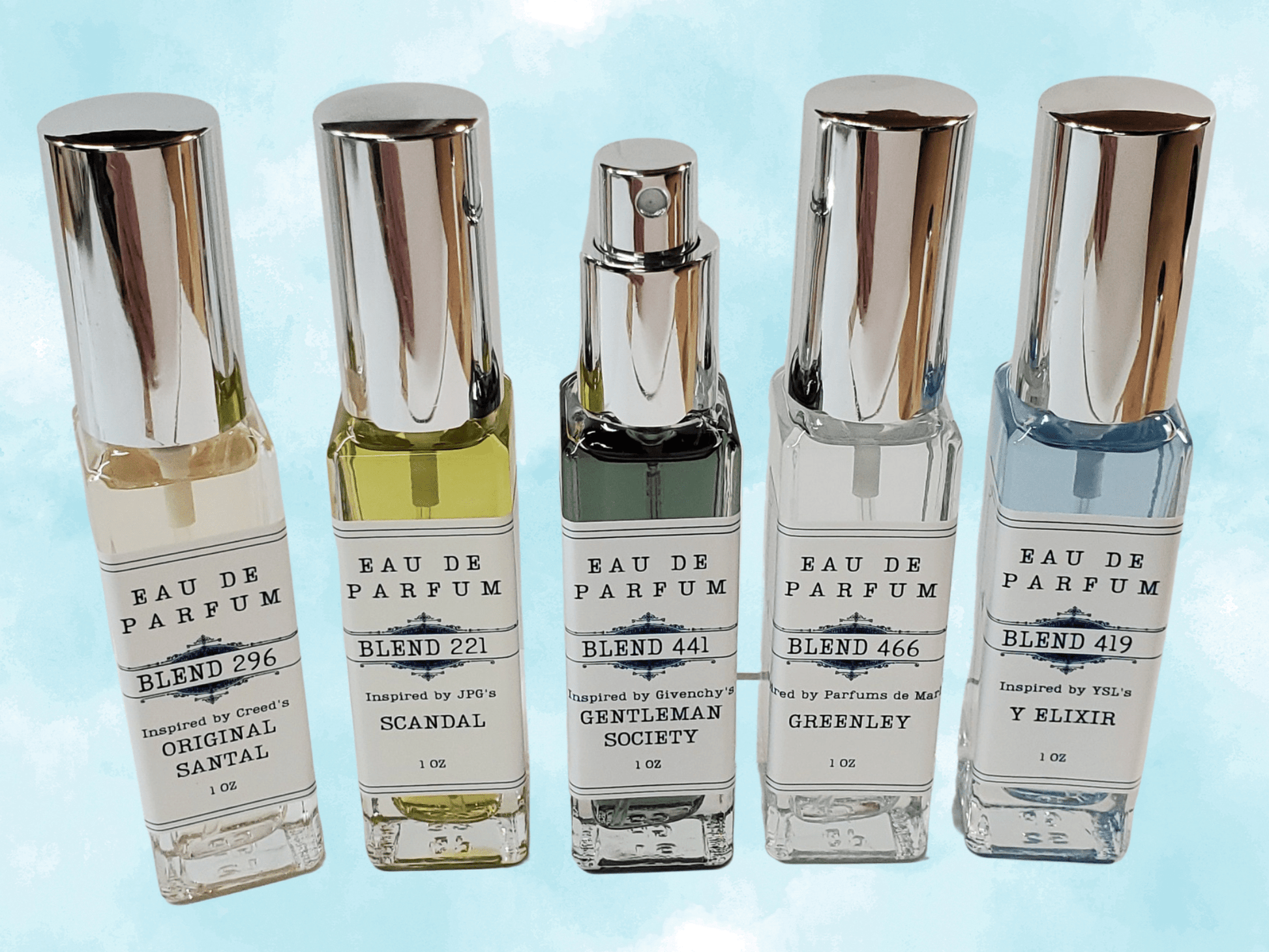 Five men's one ounce spray bottles with silver sprays and caps, filled with colorful eau de parfum, with a light blue sky background.