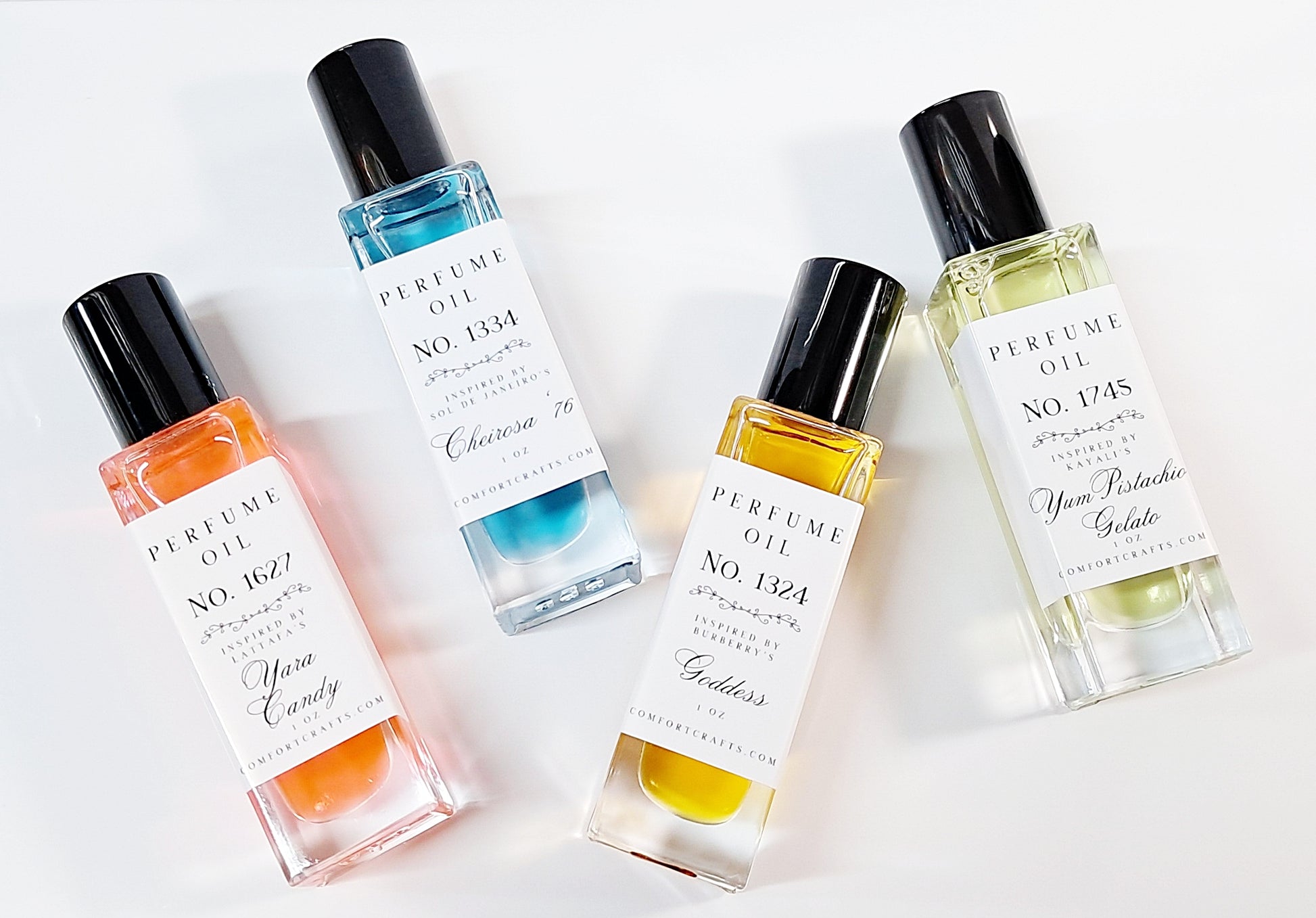 Four colorful 1 oz bottles of women's perfume oil 